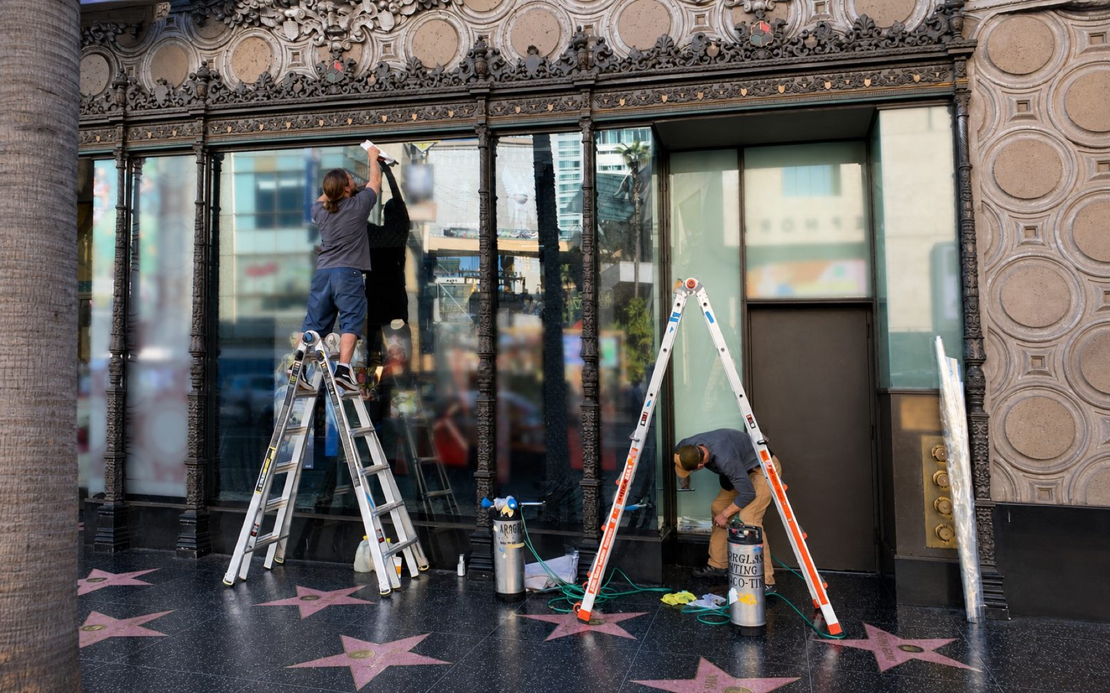 AGS installers applying clear anti-graffiti film to a Hollywood Walk of Fame storefront