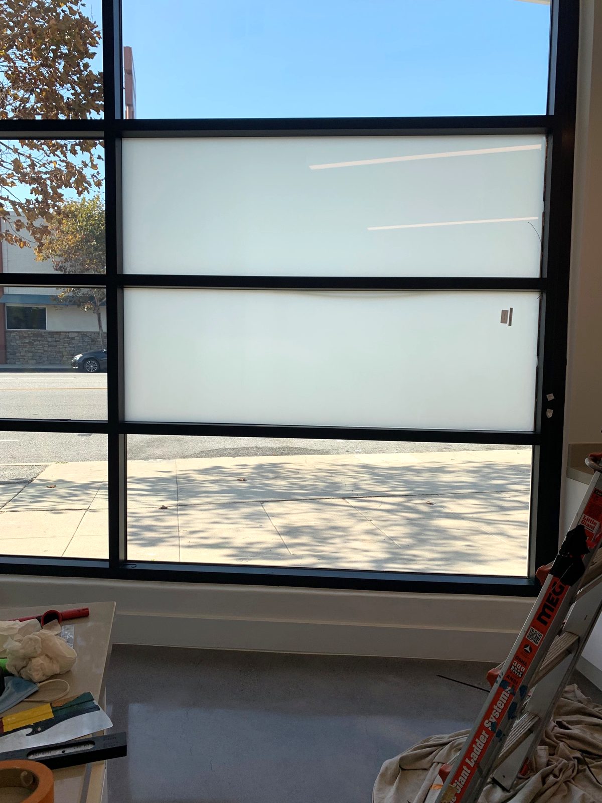 Floor-to-ceiling smart film switched to private mode inside the dental office