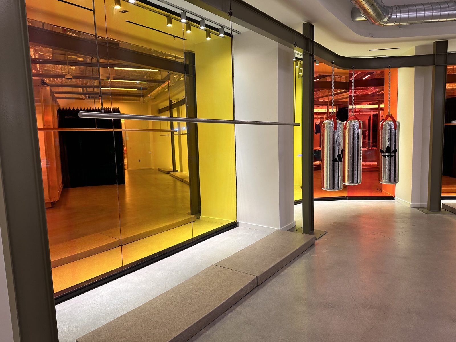 Retail glass bays wrapped in gold and crimson 3M Dichroic Blaze film
